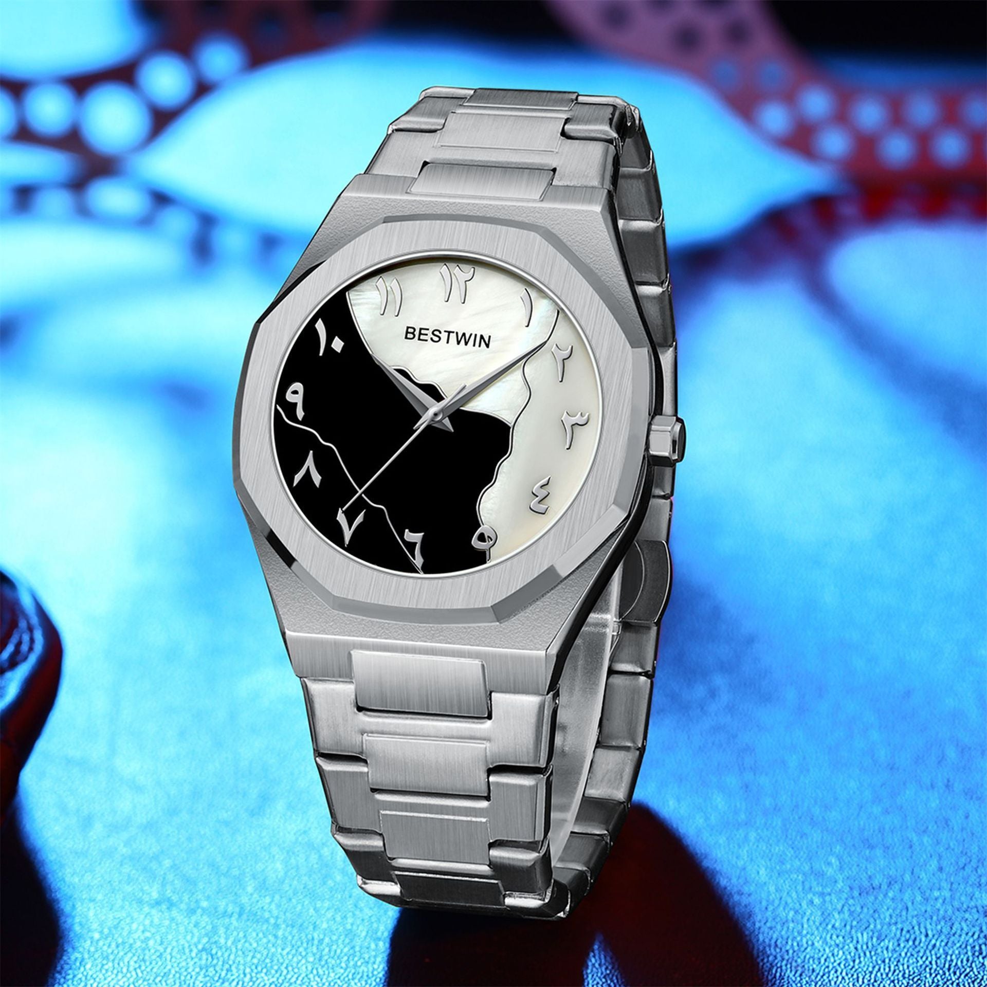 Silver wristwatch with a black and white face on a blue background