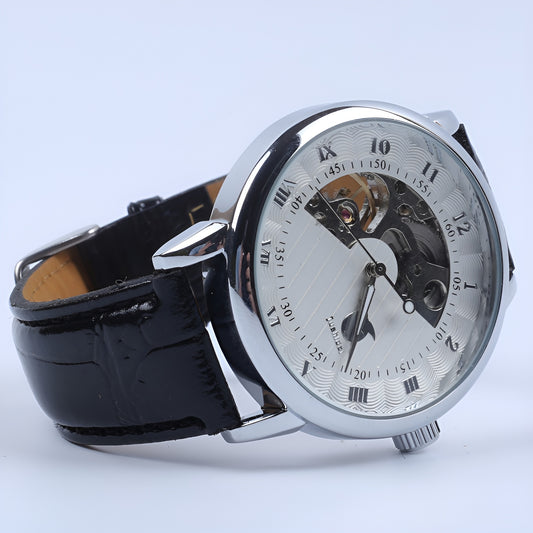 Mechanical watch with black strap and silver case on a light blue background