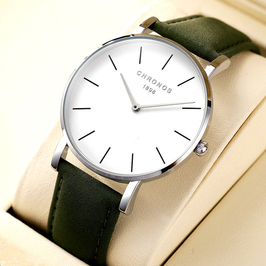 Wristwatch with green strap and white dial on beige background