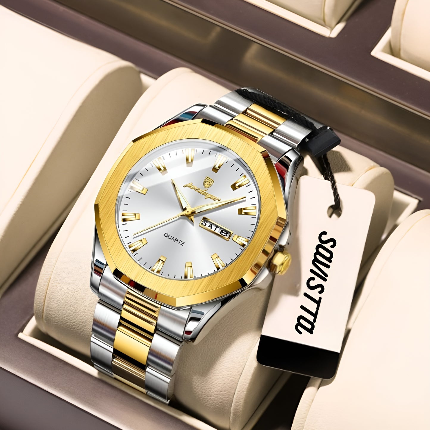 Gold and silver watch with a visible brand tag on a beige cushion