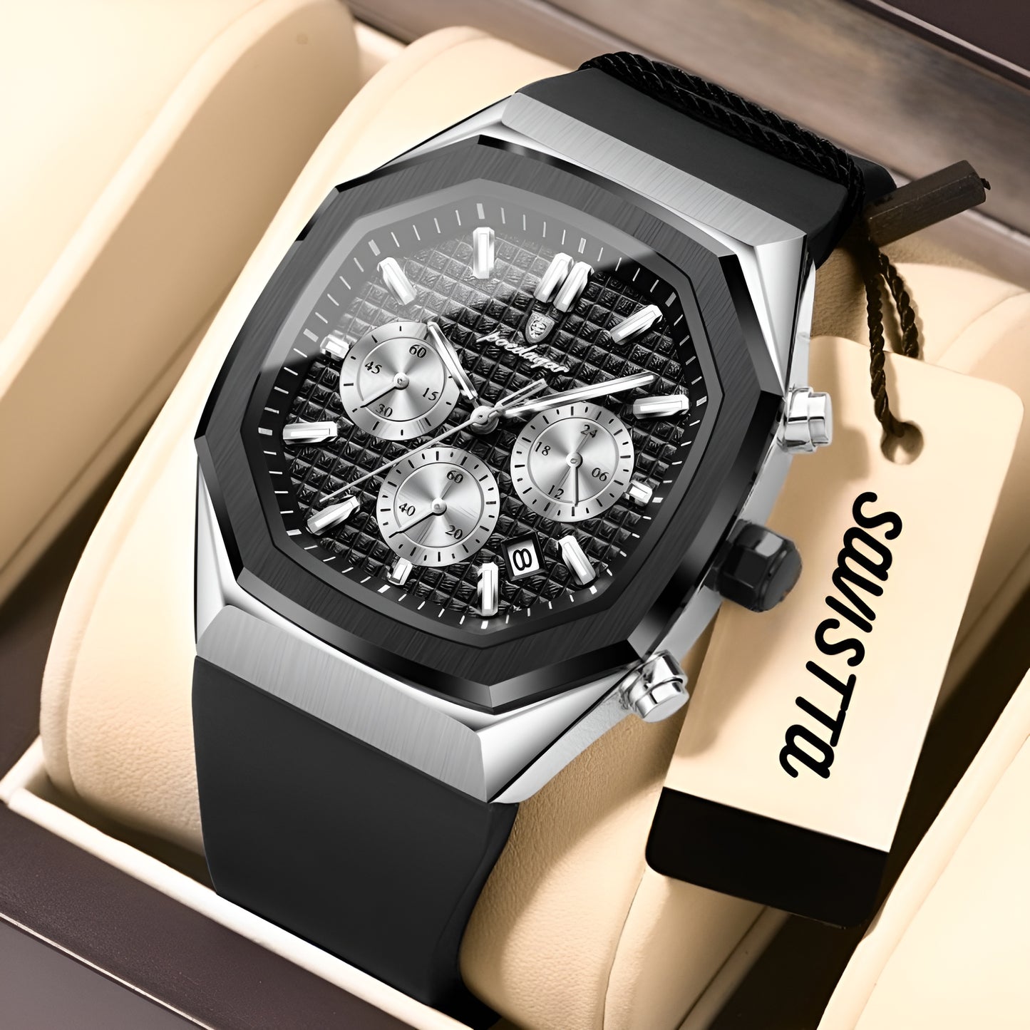 Luxury watch with black strap and detailed face on a beige cushion, brand tag visible.