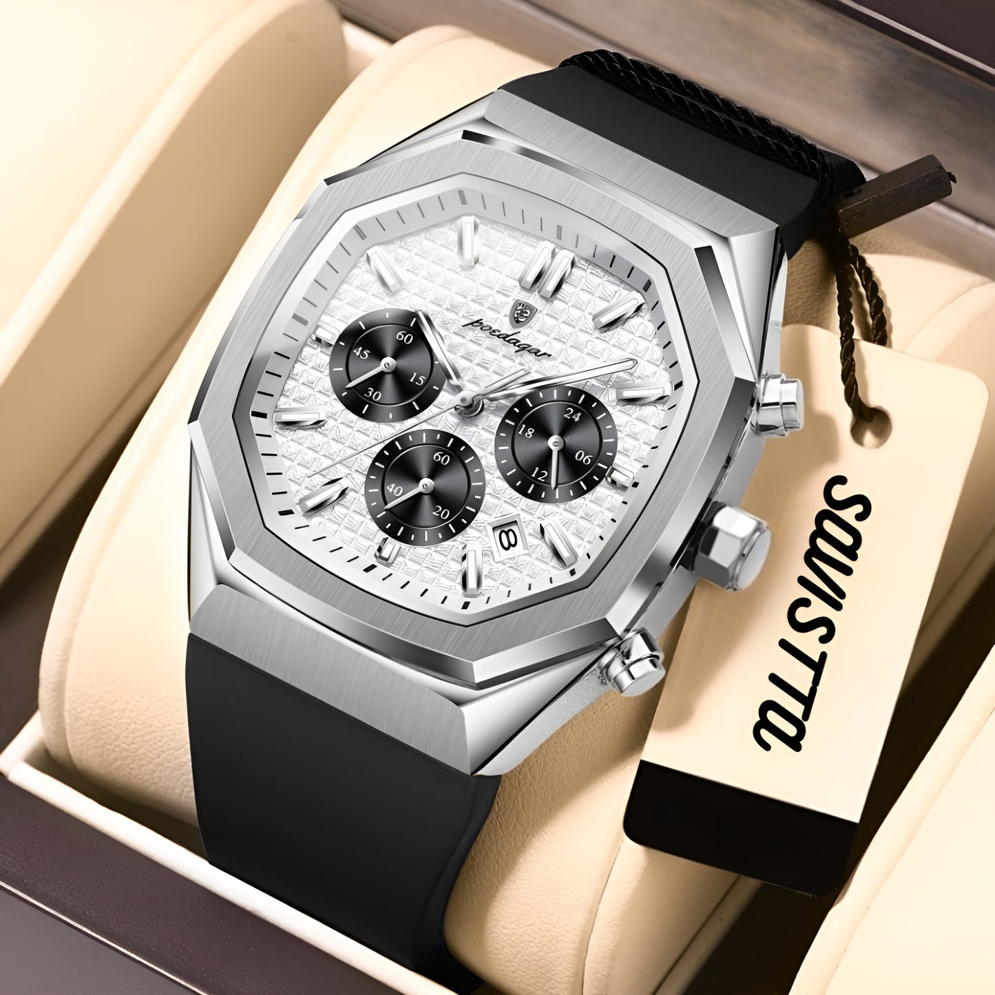 Luxury watch with black strap and silver case on a beige cushion, brand name visible