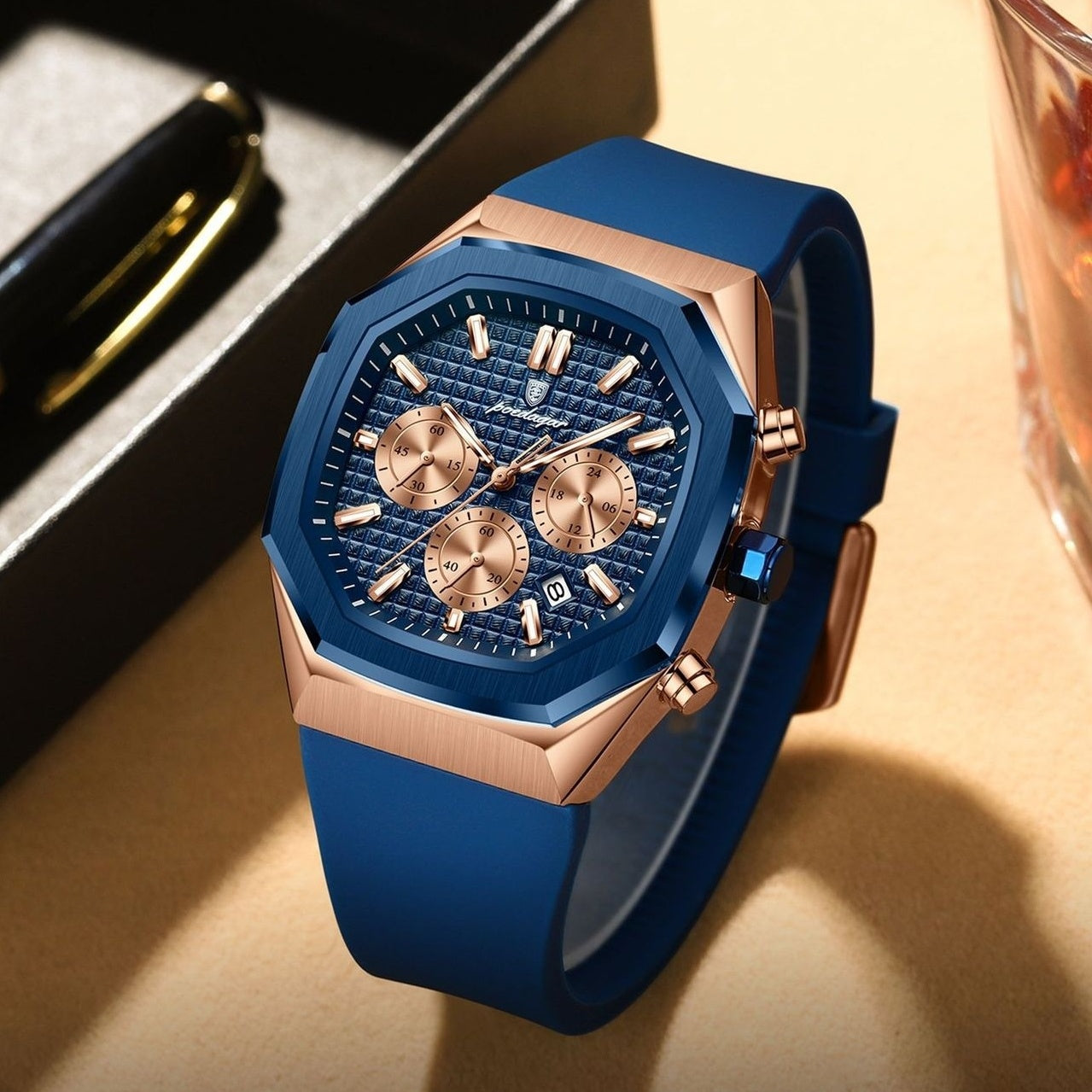 Blue and rose gold watch on a textured surface