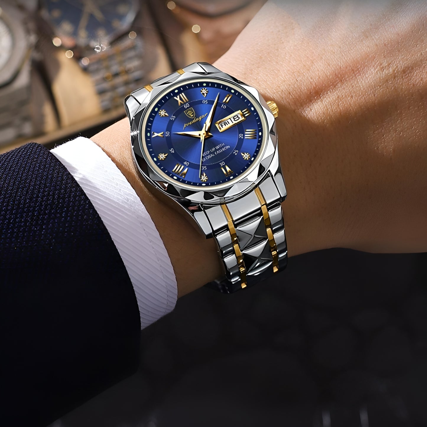 Luxury watch with blue dial and silver bracelet on a person's wrist.