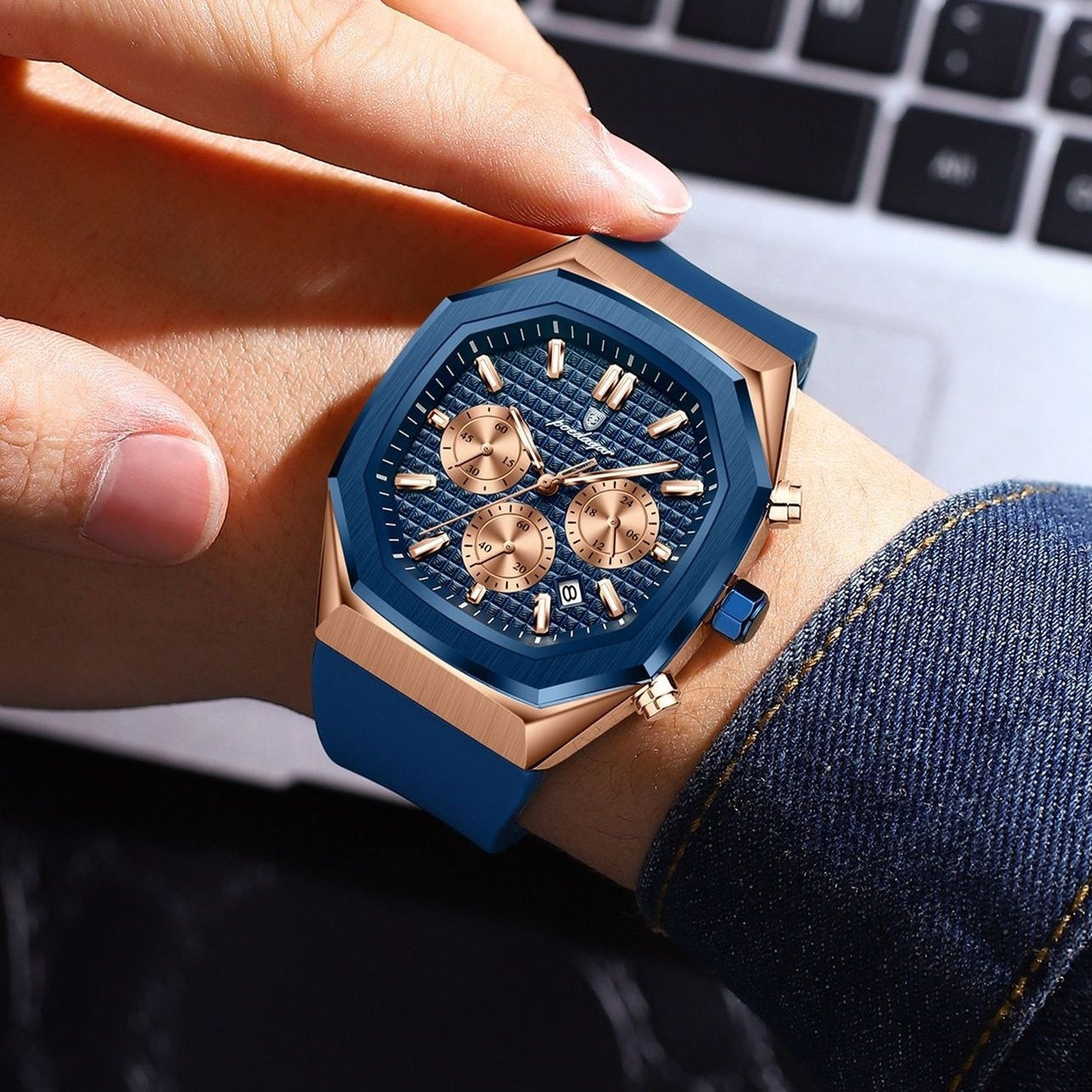 Blue and gold watch on a wrist with a blurred background